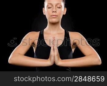 Portrait of young Caucasian woman exercising yoga with hands clasped