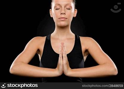 Portrait of young Caucasian woman exercising yoga with hands clasped