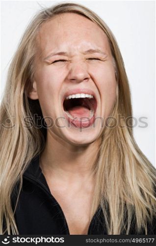 Portrait of young Caucasian woman screaming