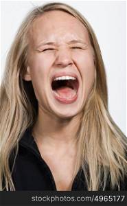 Portrait of young Caucasian woman screaming