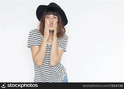 portrait of young cheerful beautiful girl with long hair in casual t-shirt looking at camera with face expression