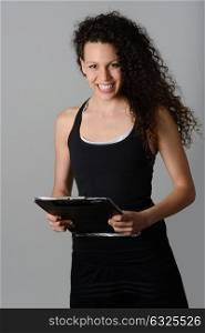 Portrait of young cheerful smiling woman in sports wear
