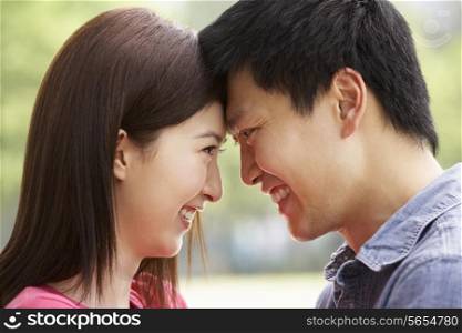 Portrait Of Young Chinese Couple Looking At Each Other