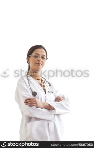 Portrait of young confident female doctor standing against white background