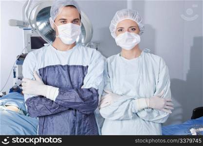 Portrait of young confident surgeons in operation theatre
