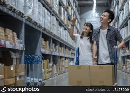 Portrait of young couple asian shopping new lifestyle of stock product inventory on shelf , logistic business shipping and delivery service