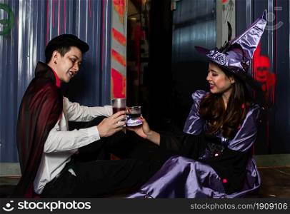 Portrait of young couple dressing witch and halloween witch and dracula costume