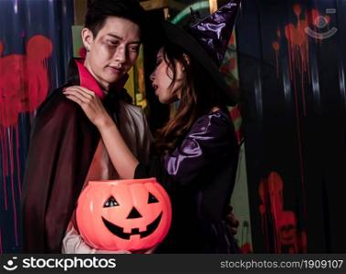 Portrait of young couple dressing witch and halloween witch and dracula costume