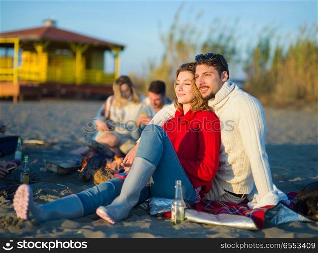 portrait of young couple having fun on beach during autumn sunny day. couple on a beach at autumn sunny day