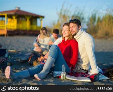 portrait of young couple having fun on beach during autumn sunny day. couple on a beach at autumn sunny day