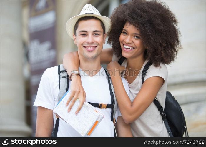 portrait of young couple holding map