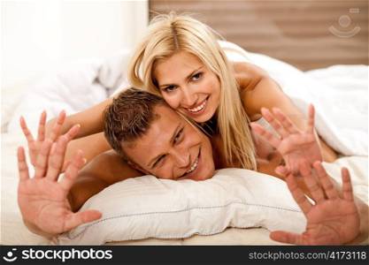 Portrait of young couple in bed