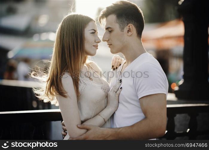 Portrait of young couple in love, enjoying the sunset in city. Portrait of young couple in love, enjoying the sunset in city.