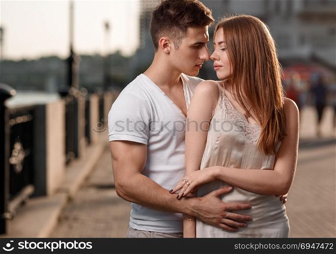 Portrait of young couple in love, enjoying the sunset in city. Portrait of young couple in love, enjoying the sunset in city.