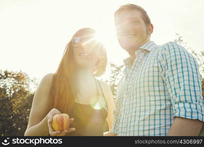 Portrait of young couple in sunlit in park