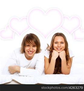 Portrait of young couple in white with heart symbols
