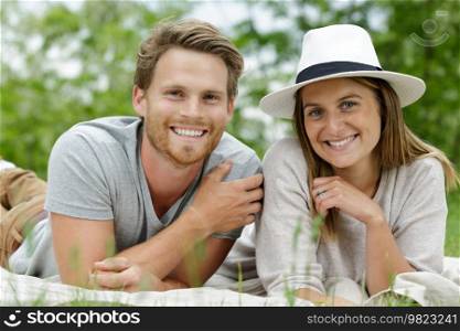 portrait of young couple layed on the grass