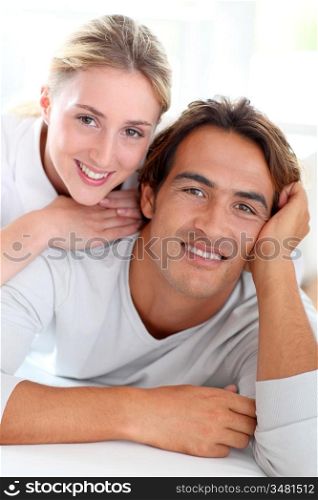 Portrait of young couple laying down sofa