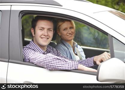 Portrait Of Young Couple Looking Out Of Car Window