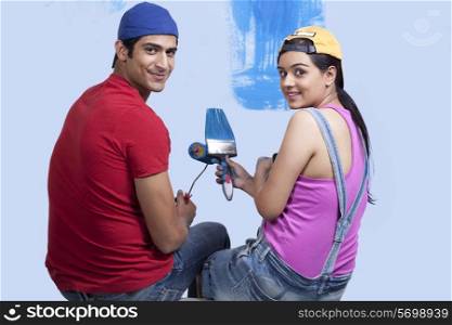 Portrait of young couple looking over shoulder