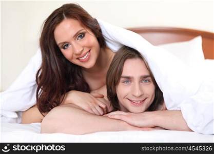 portrait of young couple of lovers in bed