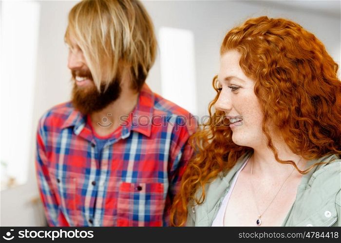Portrait of young couple. Portrait of young couple in casual wear indoors