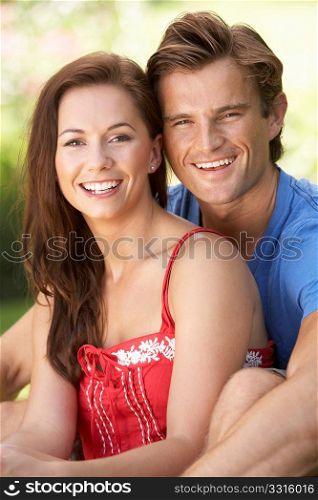 Portrait Of Young Couple Relaxing In Park
