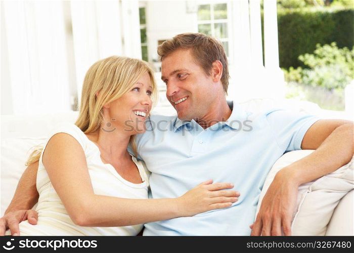 Portrait Of Young Couple Relaxing Together On Sofa