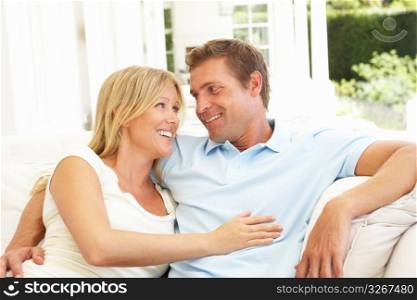Portrait Of Young Couple Relaxing Together On Sofa