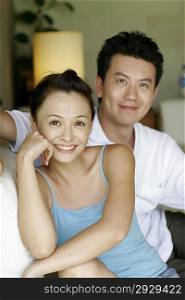 Portrait of young couple sitting together