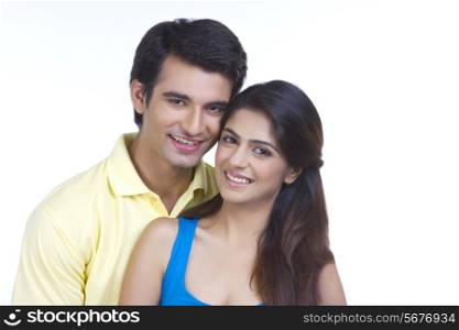 Portrait of young couple smiling together over white background