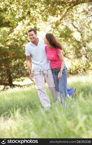 Portrait Of Young Couple Walking In Park