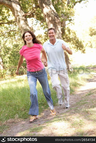 Portrait Of Young Couple Walking In Park