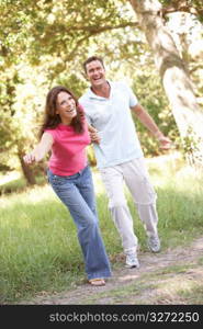 Portrait Of Young Couple Walking In Park