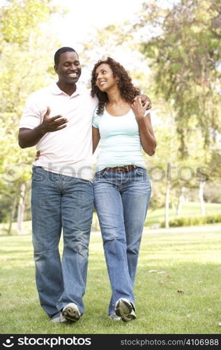 Portrait Of Young Couple Walking In Park