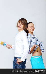 Portrait of young couple with paint brushes