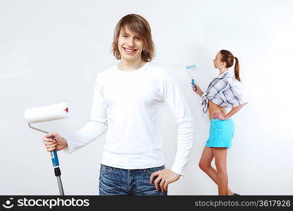 Portrait of young couple with paint brushes