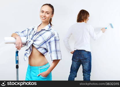 Portrait of young couple with paint brushes