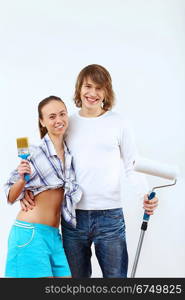 Portrait of young couple with paint brushes