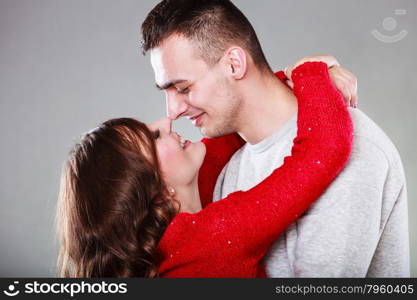 Portrait of young couple woman man face to face gray background