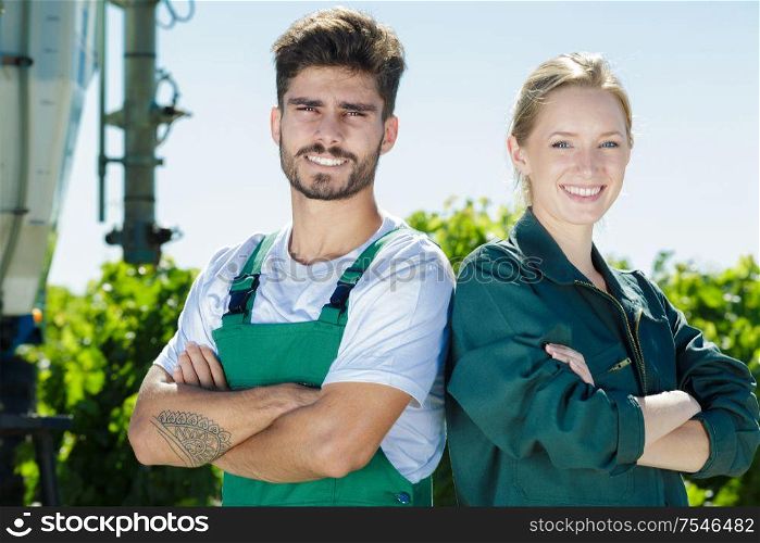 portrait of young couple working on vineyard