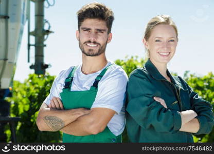 portrait of young couple working on vineyard