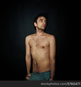 Portrait of young cute nude man on a black background