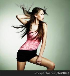 Portrait of young dancing woman with long flowing hair