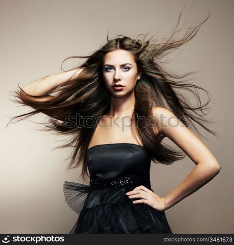 Portrait of young dancing woman with long flowing hair. Fashion photo