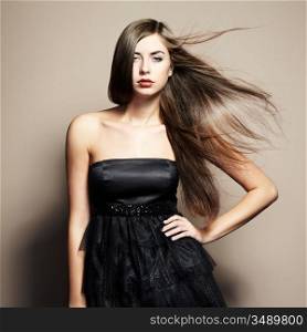 Portrait of young dancing woman with long flowing hair. Fashion photo