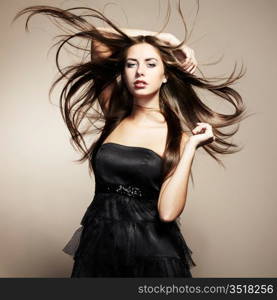 Portrait of young dancing woman with long flowing hair. Fashion photo