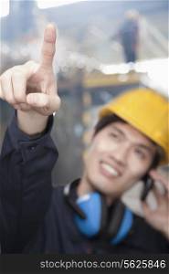 Portrait of Young Engineer Pointing