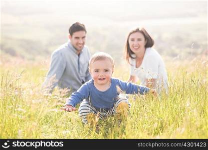 Portrait of young family in field