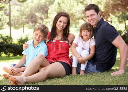 Portrait Of Young Family Relaxing In Park